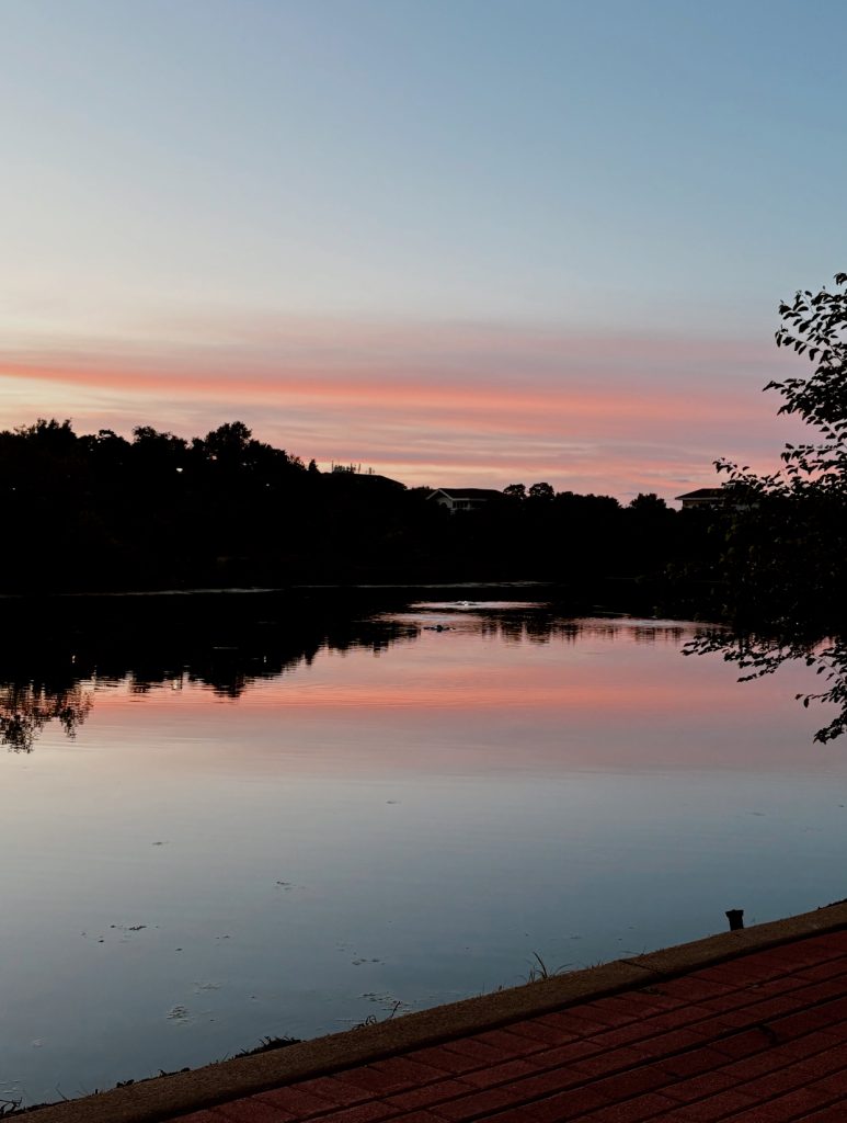 Golden summer sunset over the horizon representing slowing down and being present away from screens.