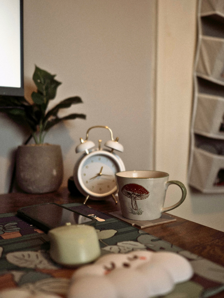 Desk with computer, mug, and clock representing making progress with the time you have