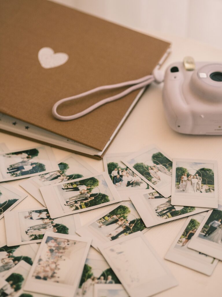 Instant camera and printed photos representing meaningful summer memories.